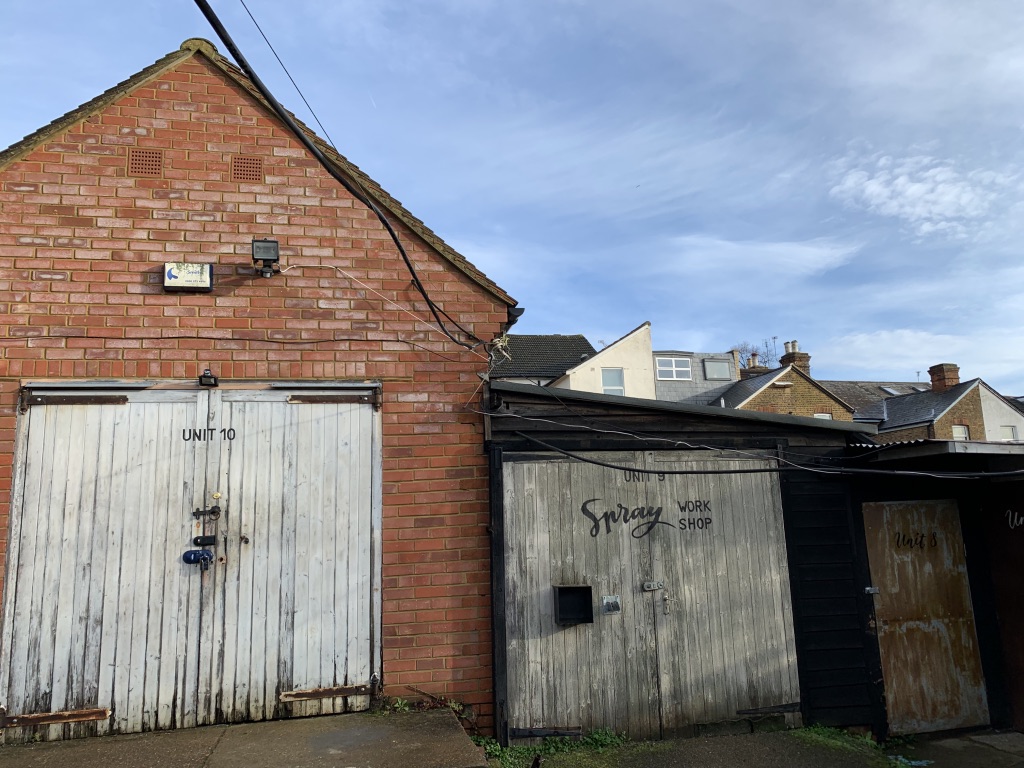 Brick workshop buildings with timber doors at a previous project site