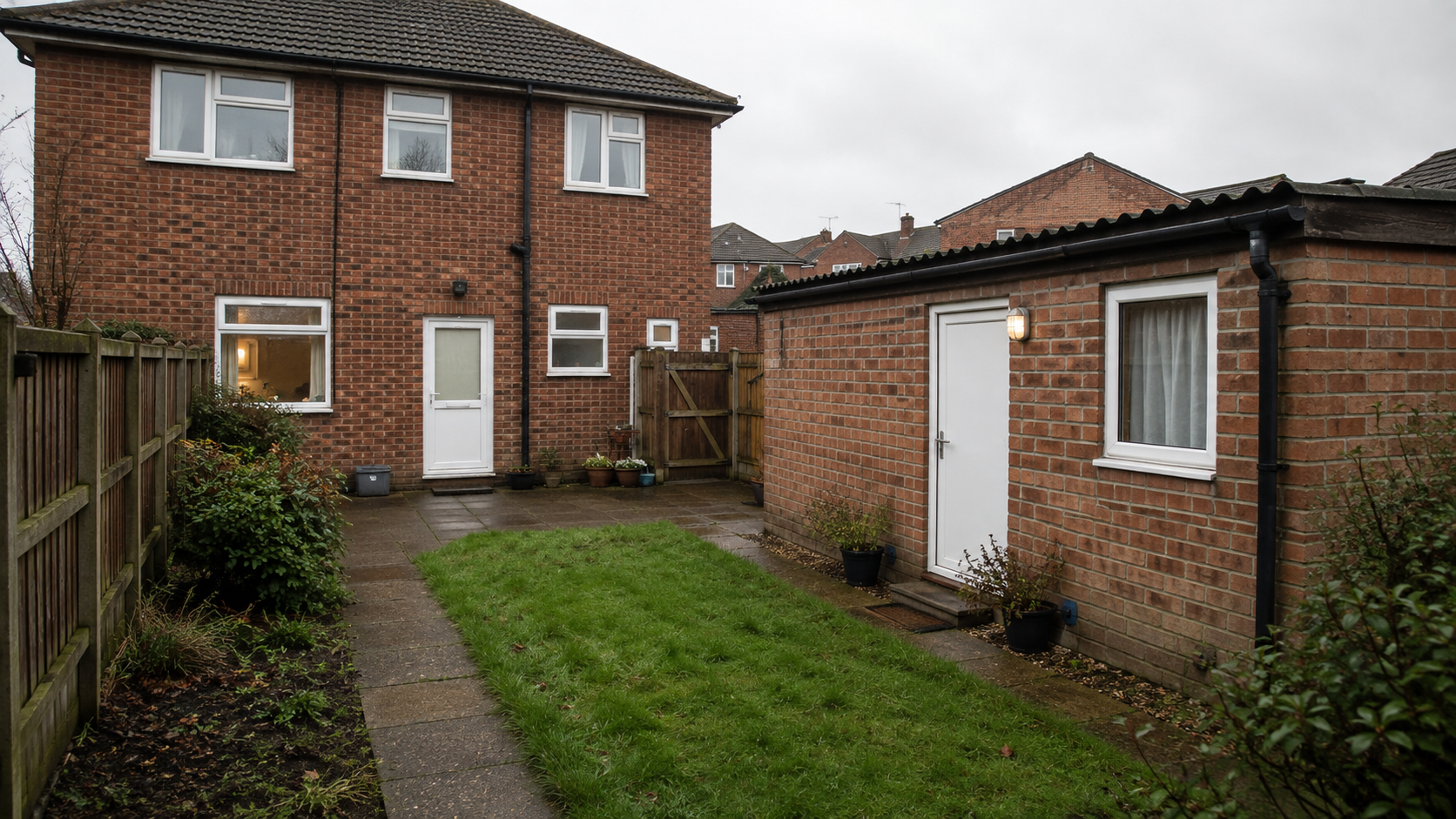 A suburban house and residential garden outbuilding in England